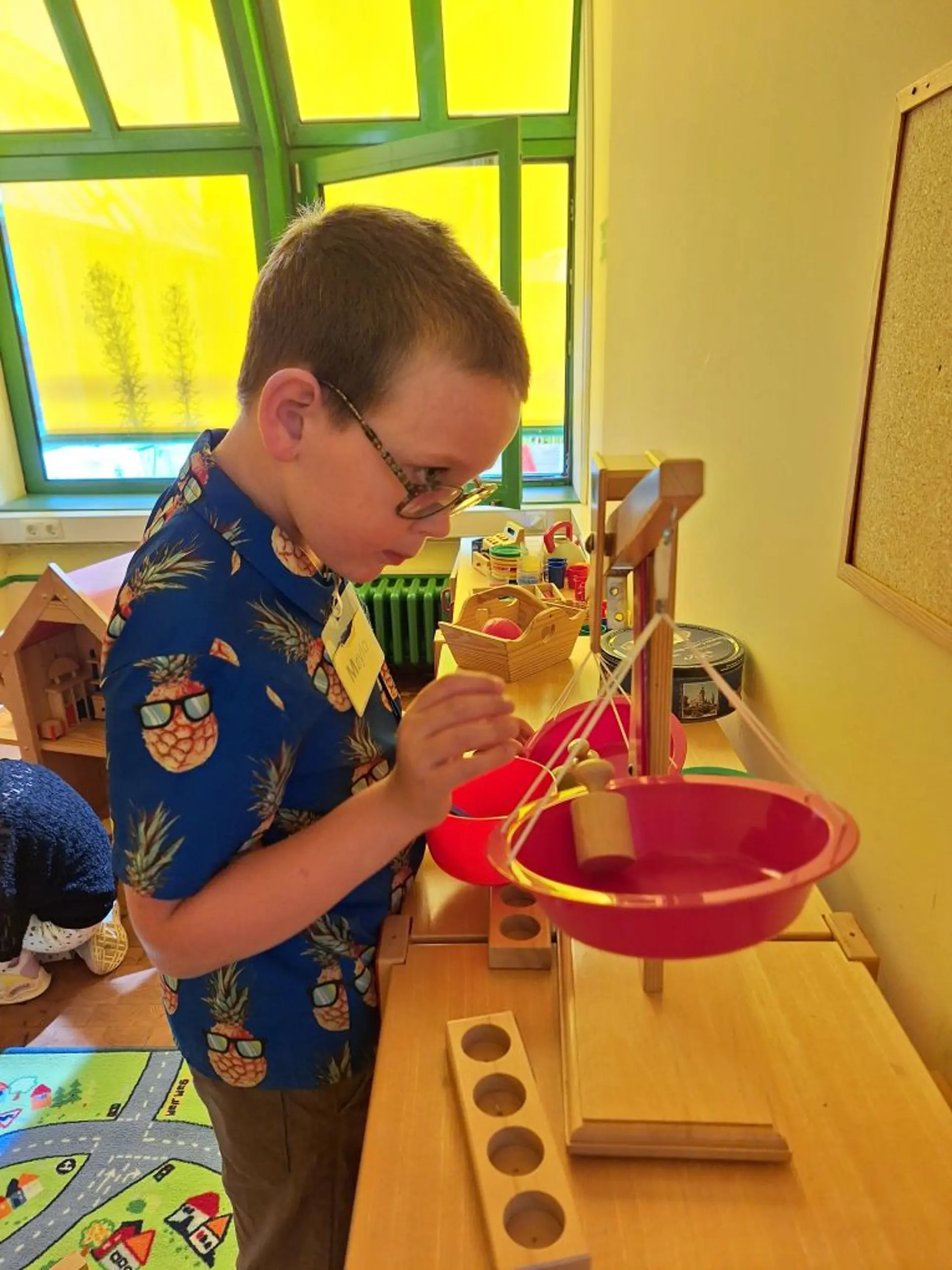 Kind spielt in der Frühförderung mit Kaufladen