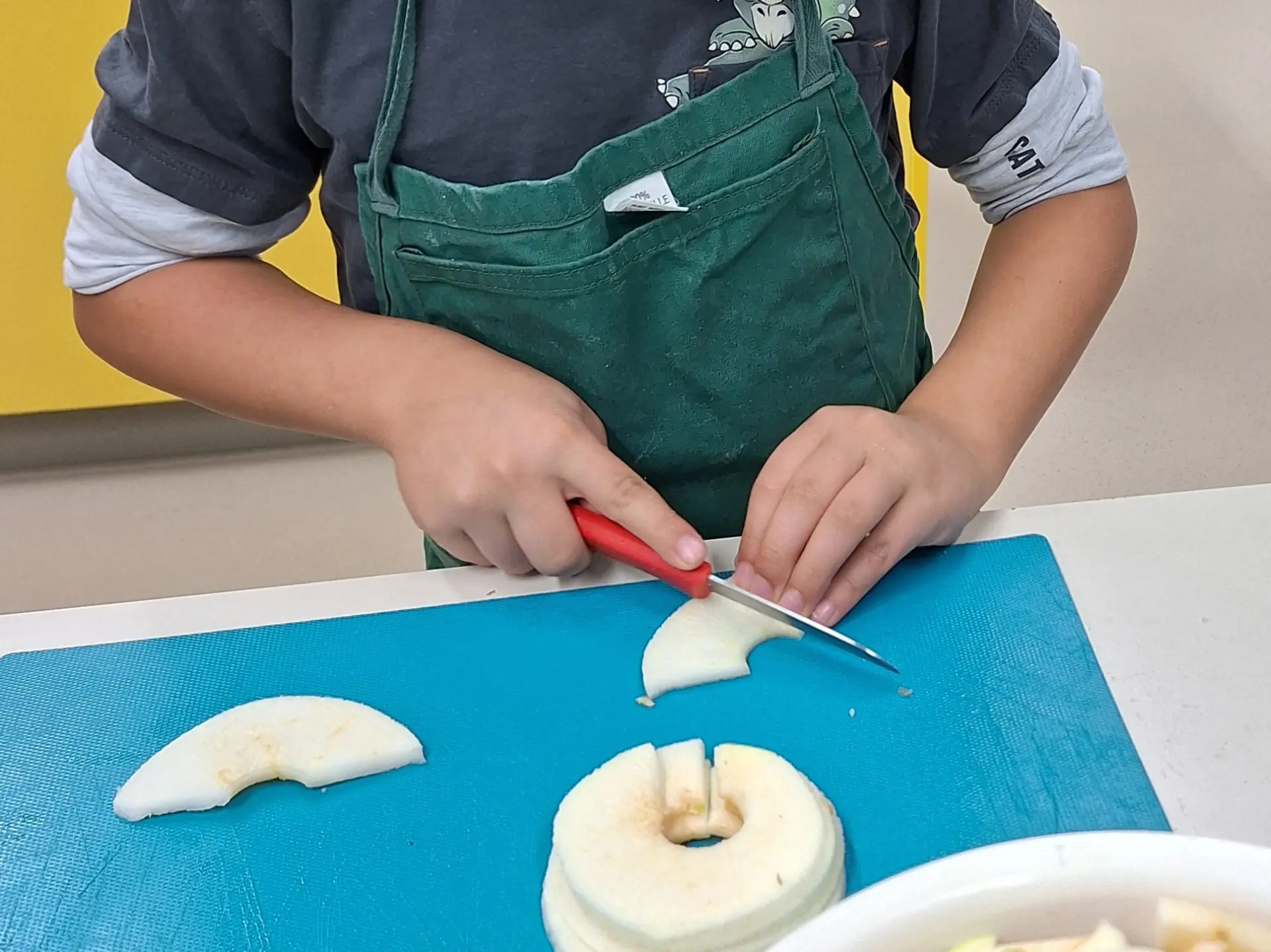 Kind schneidet Äpfel zum Backen